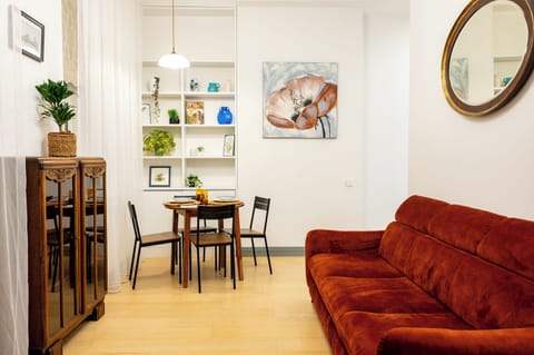 Living room with sofa and table with four chairs.