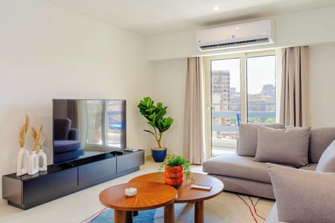 Apartment, Balcony, City View | Living area | 55-inch Smart TV with digital channels