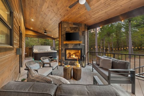 Outdoor living at its finest. Cozy seating, a glowing fireplace, and a hot tub only steps away set the scene for unforgettable nights.
