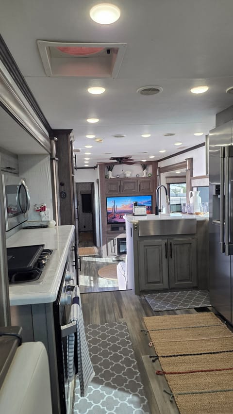 Chef-ready kitchen with stainless steel appliances and full size sink and fridge