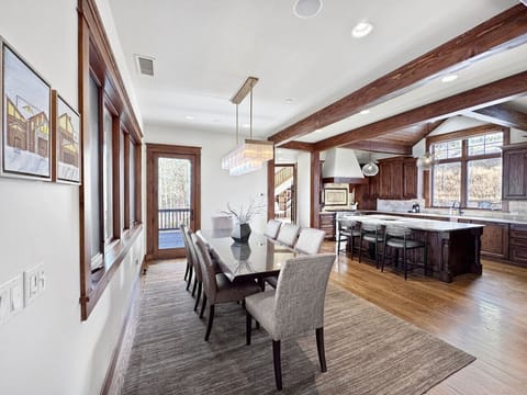 This is where you gather—table for eight, kitchen island for extras, patio doors when someone needs air. Everyone`s close, conversation`s easy, and you`re not running laps serving dinner.