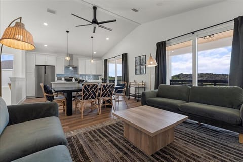 Open living room and kitchen combination featuring updated finishes, abundant natural light, and comfortable seating for groups.
