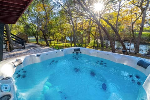 Relax in the private hot tub beneath the trees with peaceful river sounds just steps away.