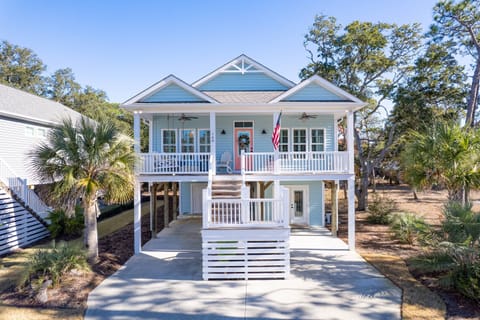 Welcome to our home! Enjoy the wrap around porch, light filled rooms, and elevated coastal layout.