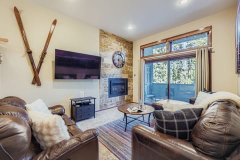 Spacious living area with smart TV, patio space, and queen pull out.
