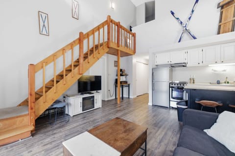 Charming wood staircase leading to the loft, adding that classic mountain lodge character.