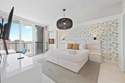 Bright master bedroom with balcony access.