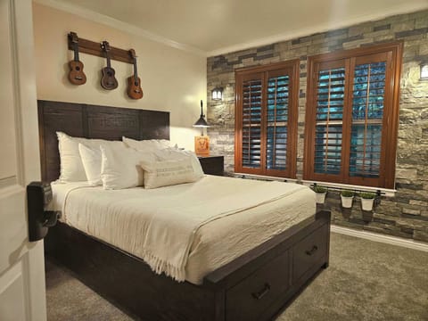 Private room with Queen Bed, mini fridge, microwave, and blackout wooden shutters