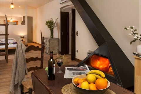 Gather around the modern fireplace in this cozy, open-plan apartment. This warm and inviting space seamlessly blends dining and relaxation.