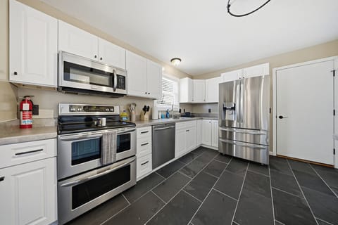 Custom-built kitchen with New electric burner stove and New refrigerator
