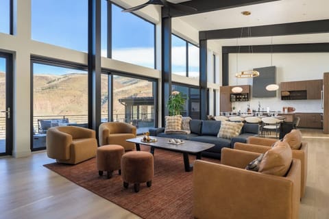 Elegant main living room with floor to ceiling windows with views and cozy gas fireplace and smart TV