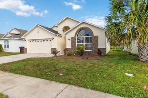 Charming family home with spacious front yard and palm trees