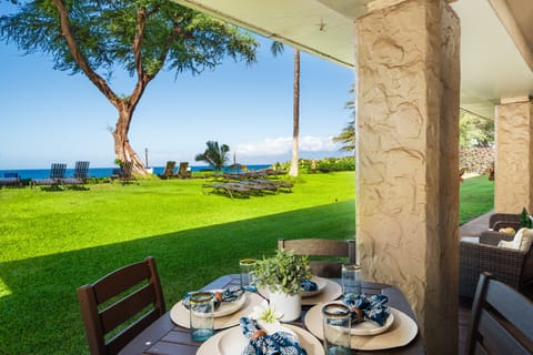 Your lanai opens to a spacious lawn with beautiful blue‑water views