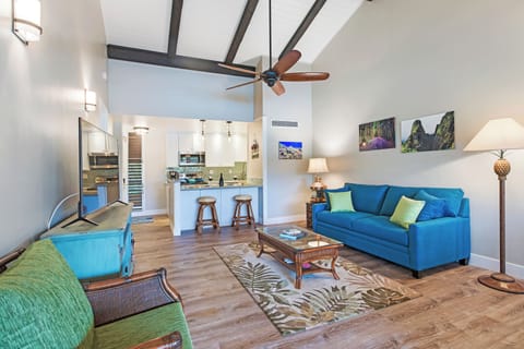 Cozy living area with plush sofa and vaulted ceilings, perfect for relaxing after a day at the beach.