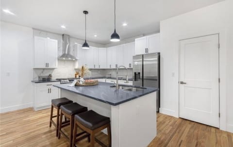 Kitchen with island and bar chairs