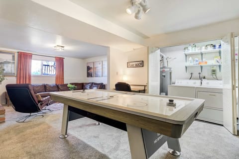 The downstairs living room opens directly to the game area, featuring an air hockey table for easy fun and friendly competition.