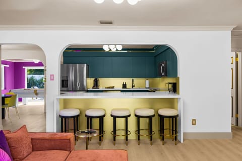 Gather around the stylish bar seating with a full view into the kitchen, perfect for meals, drinks, and social time together!