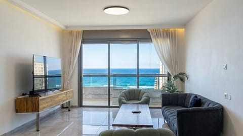 Elegant living room opens to sweeping sea views, creating calming atmosphere for relaxing evenings together.
