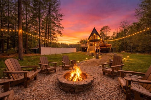 A-Frame Cabin Fire Pit with Adirondack Chairs at Sunset