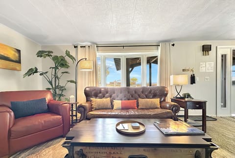 Inviting and roomy lounge space accented with tasteful decorations and a sleek smart TV