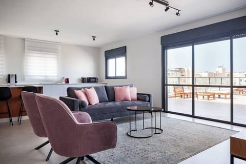 Relax in the stylish lounge before stepping onto the balcony for vibrant city views.