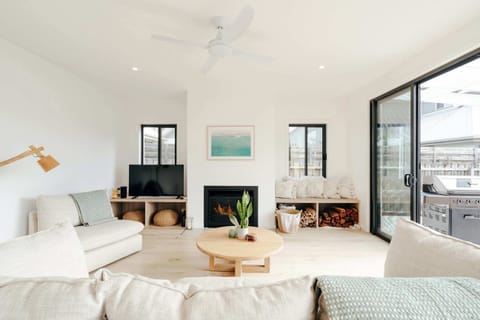 Light filled lounge with fireplace and access to covered outdoor patio