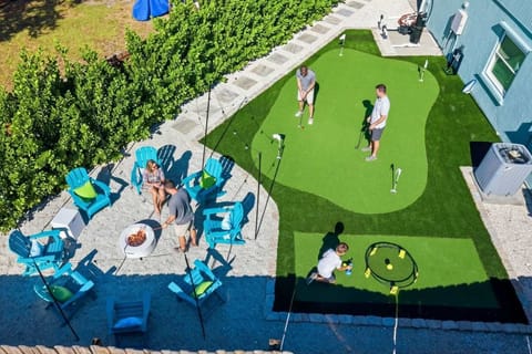 Not your average backyard—this one comes with a putting green and a firepit. Perfect for practicing your swing, telling campfire stories, and winning at both.