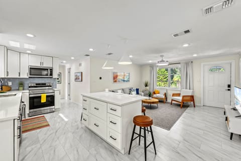 Cook with ease in this open kitchen where bright finishes flow seamlessly into the airy living space.