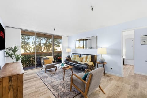Relax in a stylish, sun-filled living space featuring comfortable seating, modern amenities, and easy access to your private balcony.