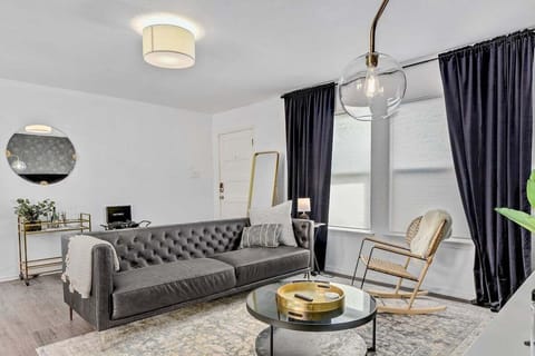 The Dolphin House Living Room with a comfortable sectional, natural light, TV