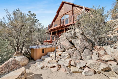 Enjoy a private outdoor retreat featuring a hot tub and gas fire pit, all set against stunning mountain views for unforgettable evenings