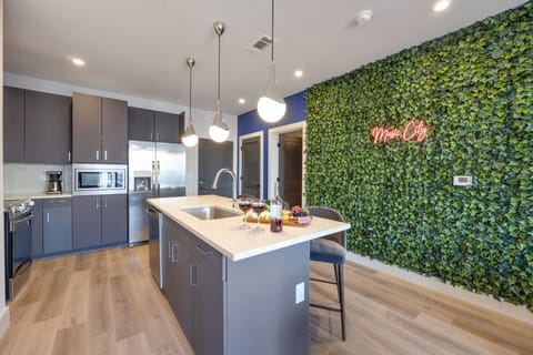 Unit 4: Fully equipped kitchen stocked with your basic cooking essentials, stainless steel appliances, and breakfast bar seating.