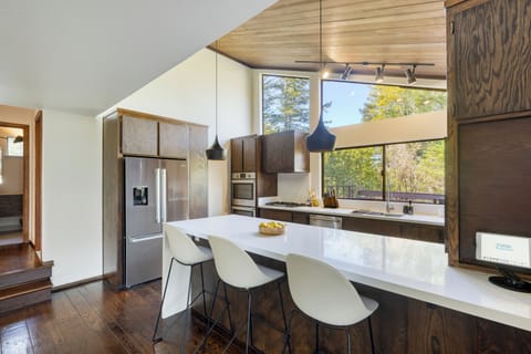 Modern kitchen with a spacious island, pendant lighting, and stunning natural light.