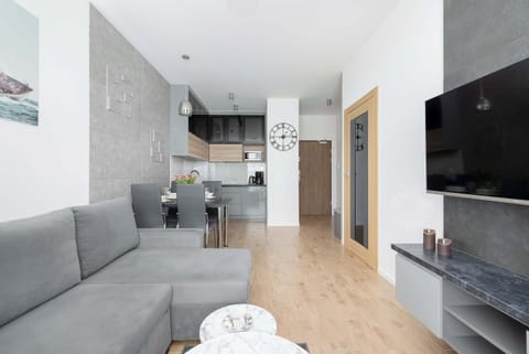 A bright living room with a comfortable sofa and a television for evening entertainment.