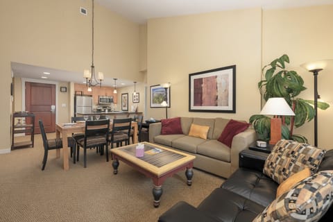 Relax in your spacious living room with plush seating, then gather around the dining table for meals from your fully equipped kitchen.