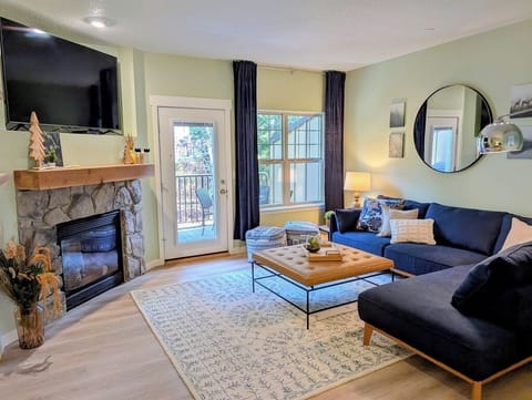 Bright living room area with a Smart TV and gas fireplace