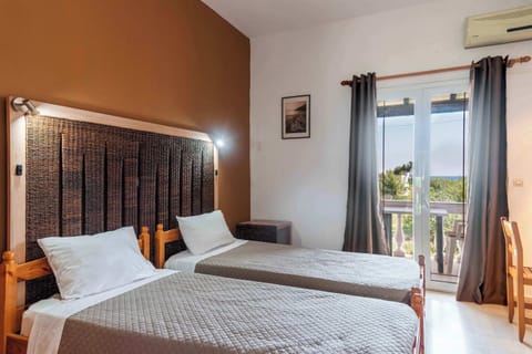 Relax in this modern, comfortable bedroom with large windows offering a beautiful view of the beach.