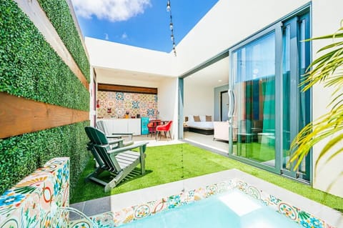 Each suite opens to a private plunge pool, framed by a wide sliding glass door.