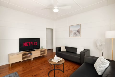 Living Area: Bright living space with comfortable seating and TV