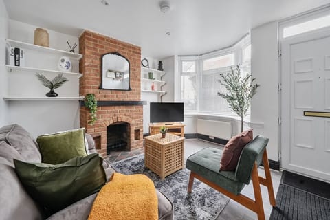 Bright and stylish lounge with cosy seating and fireplace