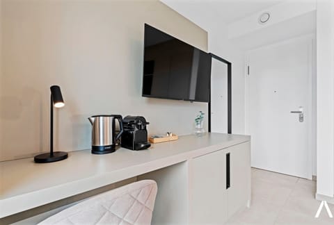 Well-Equipped Workspace and Coffee Setup – Desk space with a coffee maker and kettle for added convenience.