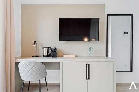 Functional Workspace and Entertainment Area – Wall-mounted TV, small desk, and a cozy chair create a perfect blend of comfort and productivity.