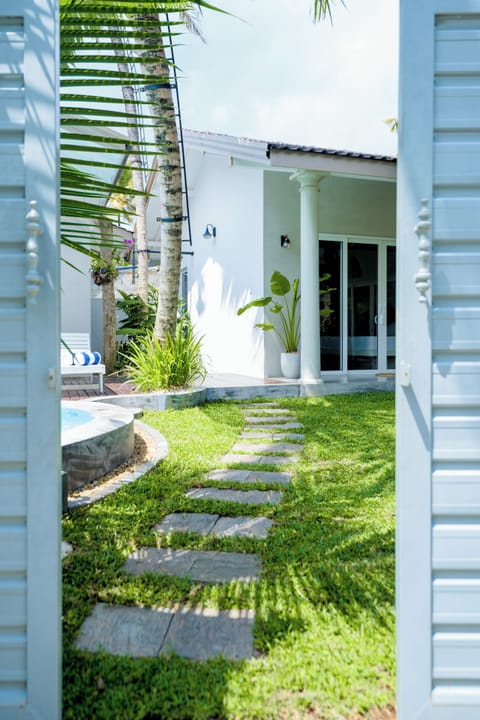 Entrance of the villa with stone pathway 