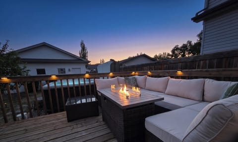 Romantic twilight retreat: glowing fire table and private, heated hot tub