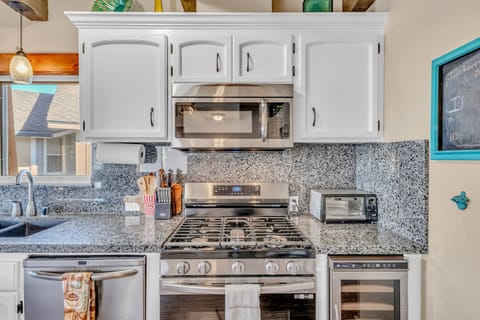 Kitchen: Drip coffee maker, toaster oven, cooking utensils, tableware