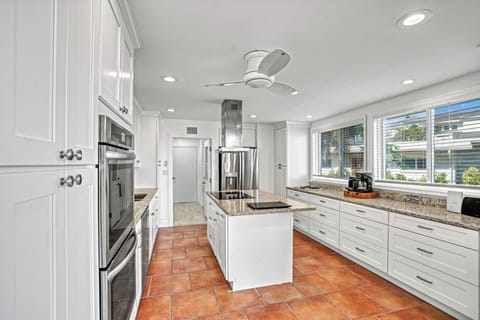 The spacious kitchen invites everyone to gather with a bright, airy layout.