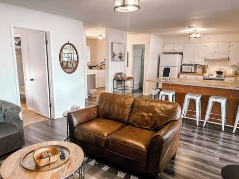 Open concept living room, dining area, and fully stocked kitchen