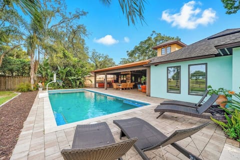 Sparkling pool framed by sunny patio lounging