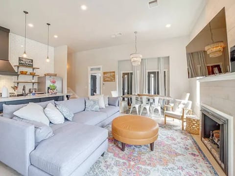 Open concept living room and kitchen with ample seating and smart TV