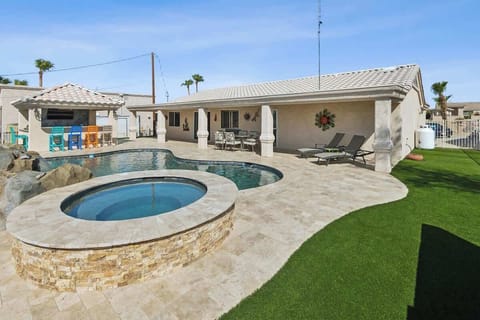 A mountain-view oasis, with a waterfall pool, hot tub, & outdoor kitchen!